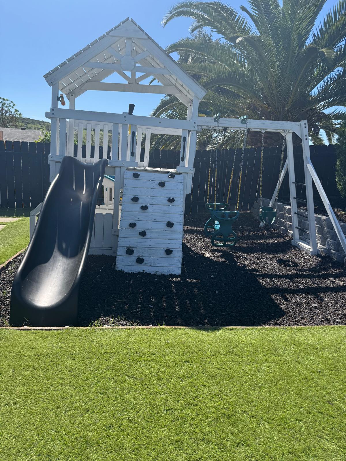 Outdoor toy area with ball pit and toddler slide