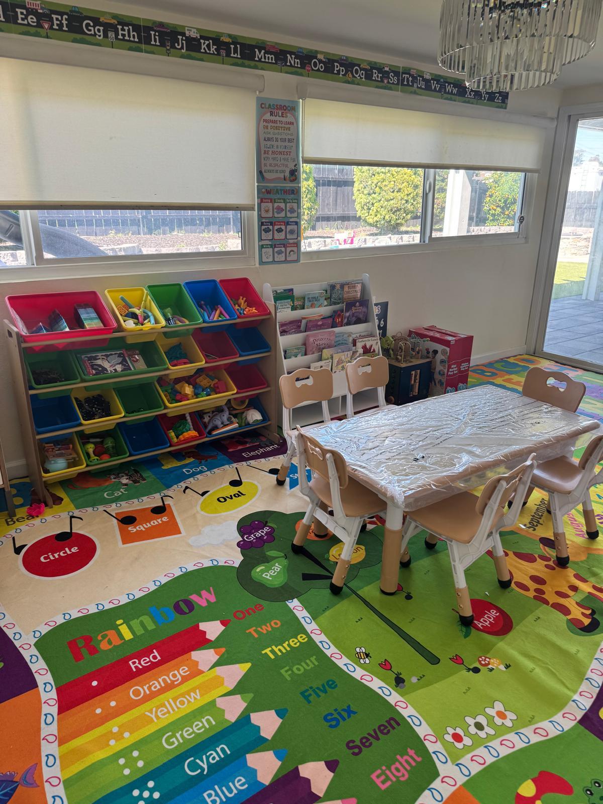 Indoor playroom with educational rug and children table